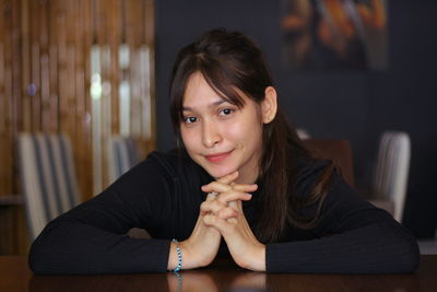 Portrait of woman sitting at home