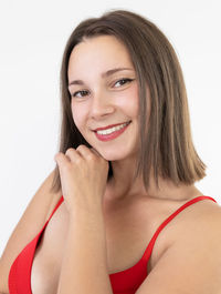 Portrait of young woman against white background