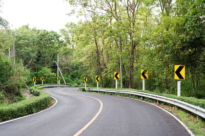 Road sign by trees