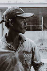 Portrait of man wearing hat looking away