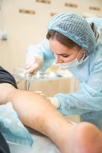 High angle view of doctor examining patient at clinic