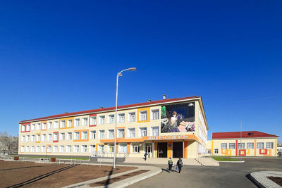 Buildings against clear blue sky in city