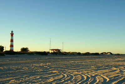 Scenic view of snow against clear sky during sunset