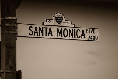 Low angle view of road sign against sky