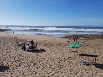 People on beach against sky