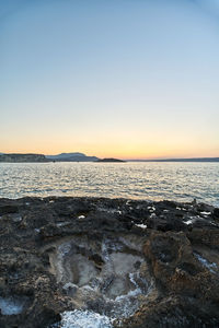 Scenic view of sea against clear sky during sunset