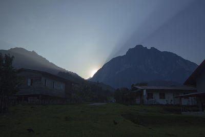 View of houses against cloudy sky