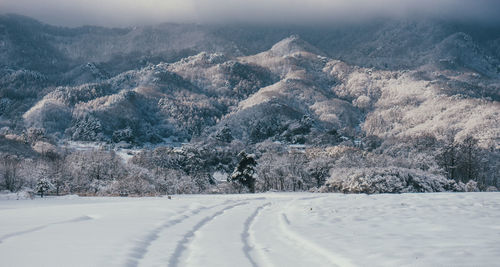 Empty road with mountains in background