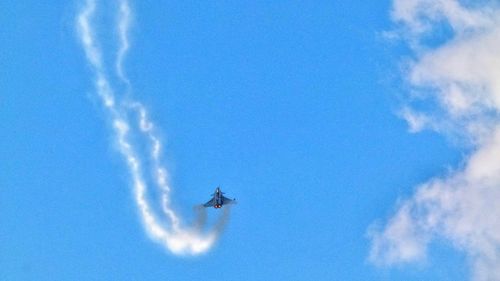 Airplane flying against blue sky