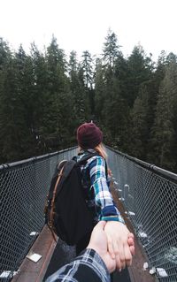 Personal perspective of couple on footbridge