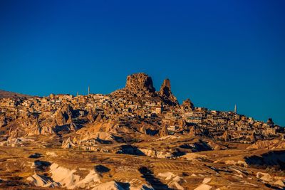 Rock formations against clear blue sky