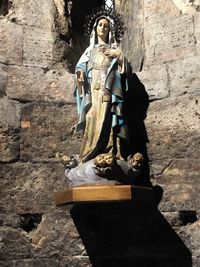 Statue of buddha against wall