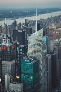 Aerial view of buildings in city against sky