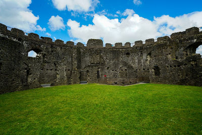 View of old ruin building against cloudy sky