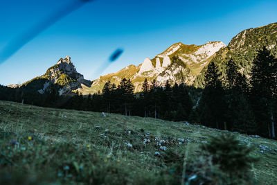 Scenic view of mountains against blue sky