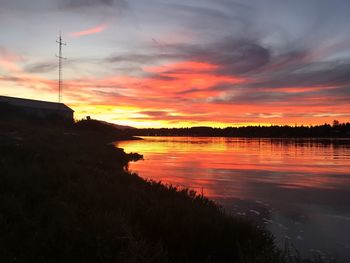 Scenic view of lake against romantic sky at sunset