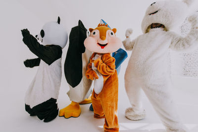 People wearing costume standing over white background