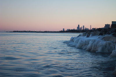 Scenic view of sea against clear sky during sunset