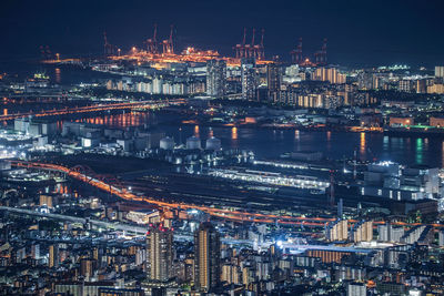 High angle view of illuminated buildings in city at night