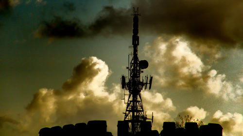 Low angle view of silhouette tower against sky during sunset