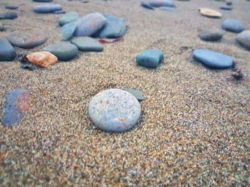 Close-up of stones on sand