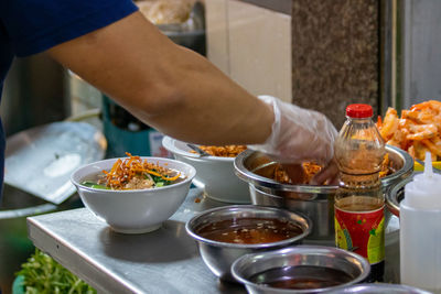 Midsection of man having food in restaurant