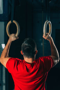 Rear view of man standing against wall