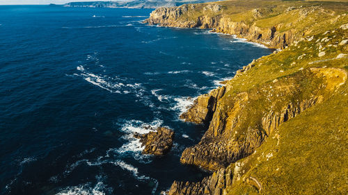 Waves crashing on the rocks of the coast aerial view