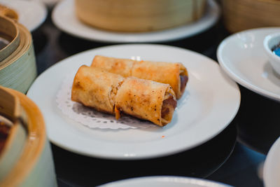 Close-up of dim sums served in plate on table