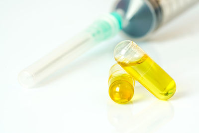 Close-up of yellow faucet on white surface