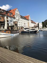 Boats moored at harbor against clear sky