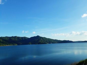 Scenic view of sea against blue sky