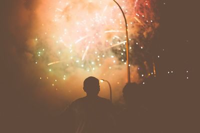 Silhouette men at watching firework display