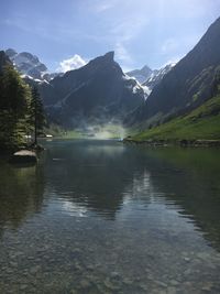 Scenic view of lake and mountains against sky