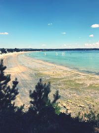 Scenic view of beach against blue sky