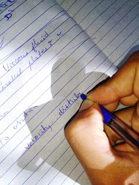 Low section of man reading book on paper