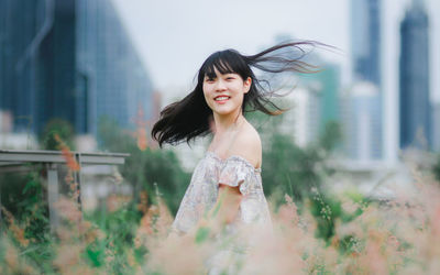 Portrait of smiling woman standing outdoors