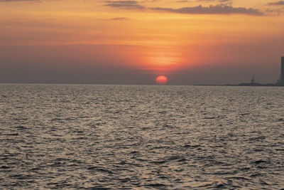 Scenic view of sea against orange sky