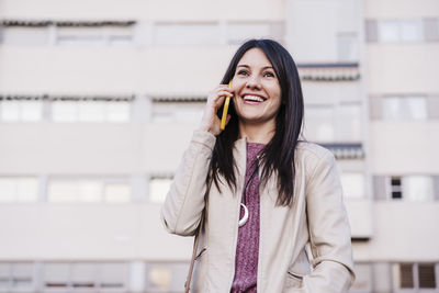Smiling young woman looking away outdoors