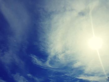 Low angle view of bright sun in sky