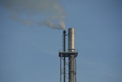 Low angle view of smoke stack against sky