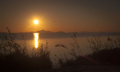 Scenic view of calm lake at sunset