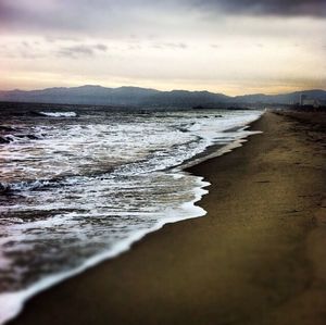 Scenic view of sea against cloudy sky