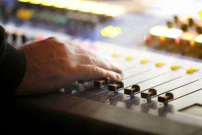 Close-up of hand operating sound mixer