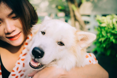 Close-up of woman holding dog