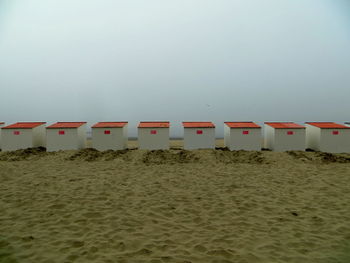 Lifeguard hut on beach against sky