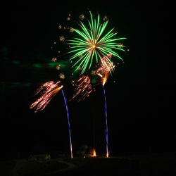 Low angle view of firework display at night