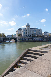 Bridge over river against buildings in city