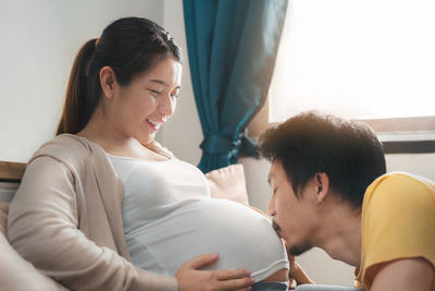 Young couple sitting on table at home