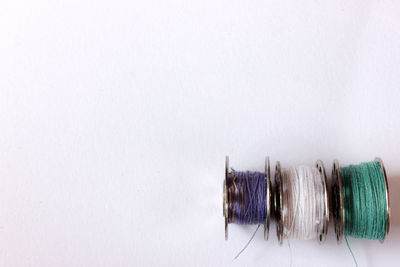 Close-up of colored pencils over white background